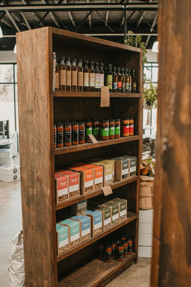 Rustic wooden shelf with assorted sauces and boxes in a local store.